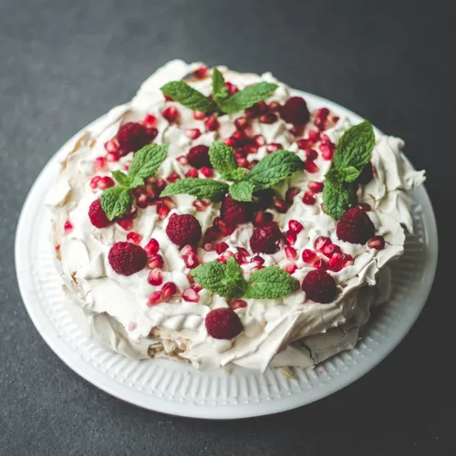 a cake with whipped cream and berries on top